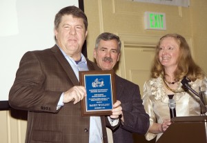 NSIA President Dan Parnel, center, and NSIA Executive Director Liz Hamilton present Randy Woolsey of Tom Posey Company with the Buzz Ramsey Foot Soldier Award for 2013. Woolsey has been a tireless advocate for the sport fishing industry.